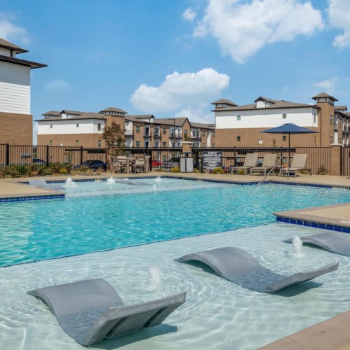 a swimming pool with buildings in the background