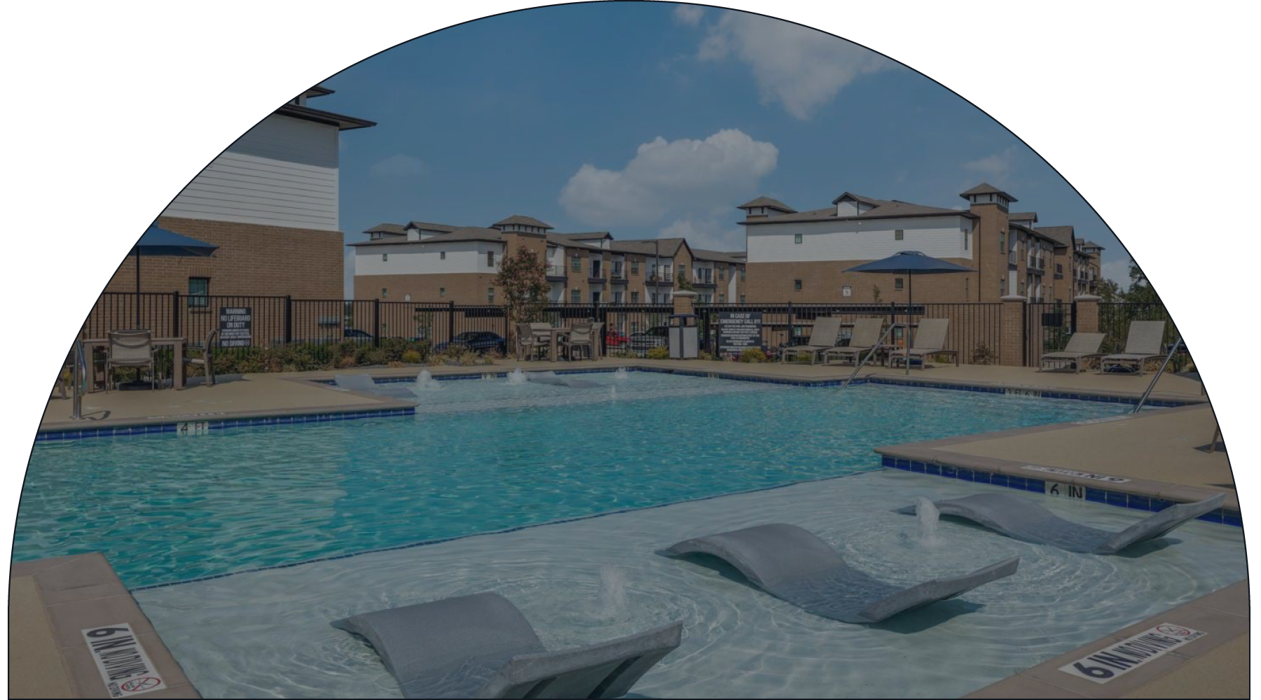 a swimming pool with buildings in the background