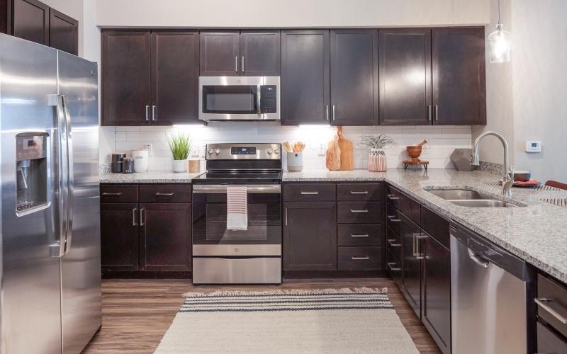 a kitchen with brown cabinets