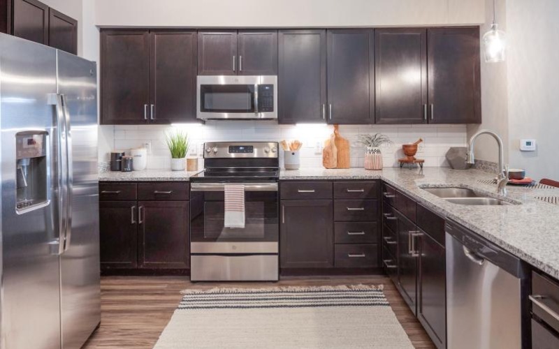 a kitchen with brown cabinets