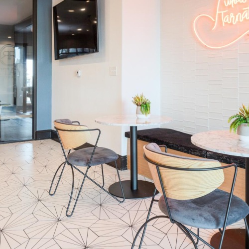 a room with a table chairs and a tv