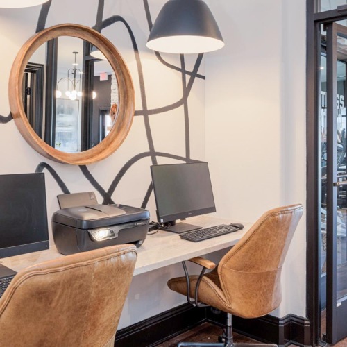 a room with a desk and computer