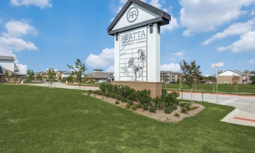 Reatta Ranch Apartment Homes monument sign at community entrance in Justin TX