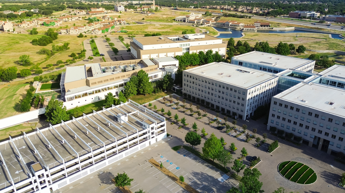 Aerial view of corporate office campus buildings and parking garages in Westlake Texas
